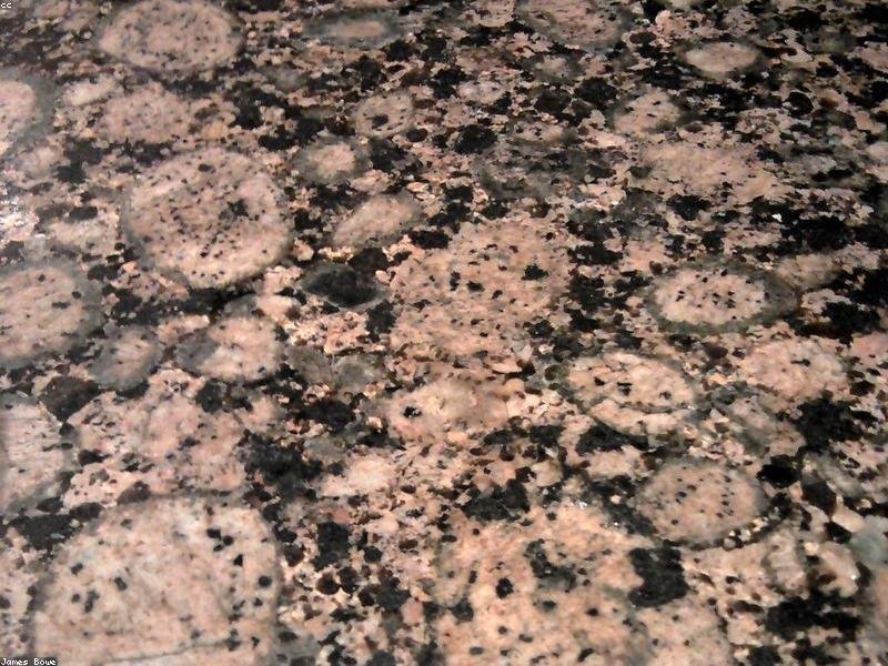 Gros plan d'un comptoir de granit naturel aux veines dramatiques et aux mouchetures chaudes